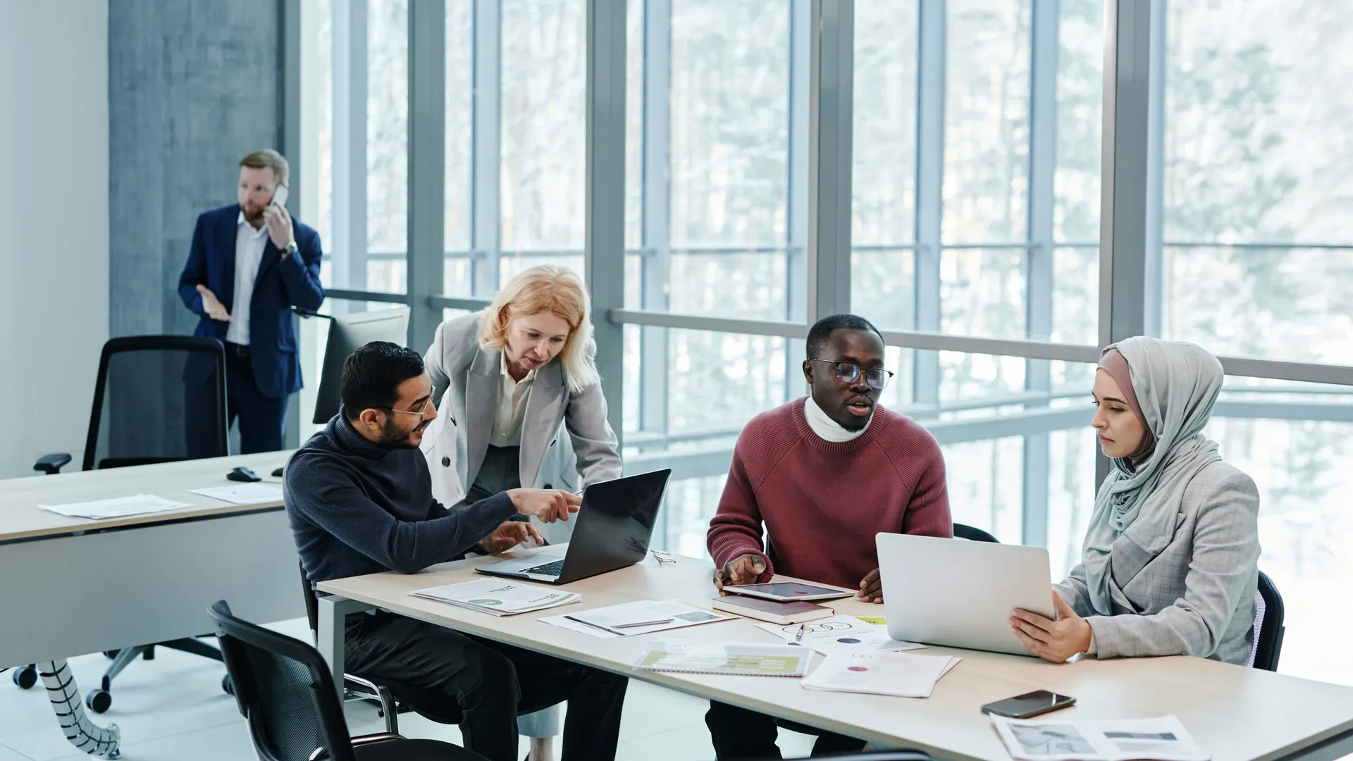 Diverse team talking through ideas in a bright modern office