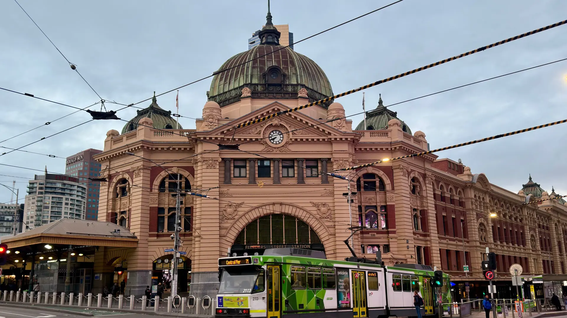 Green Melbourne tram outside Flinders Street Station