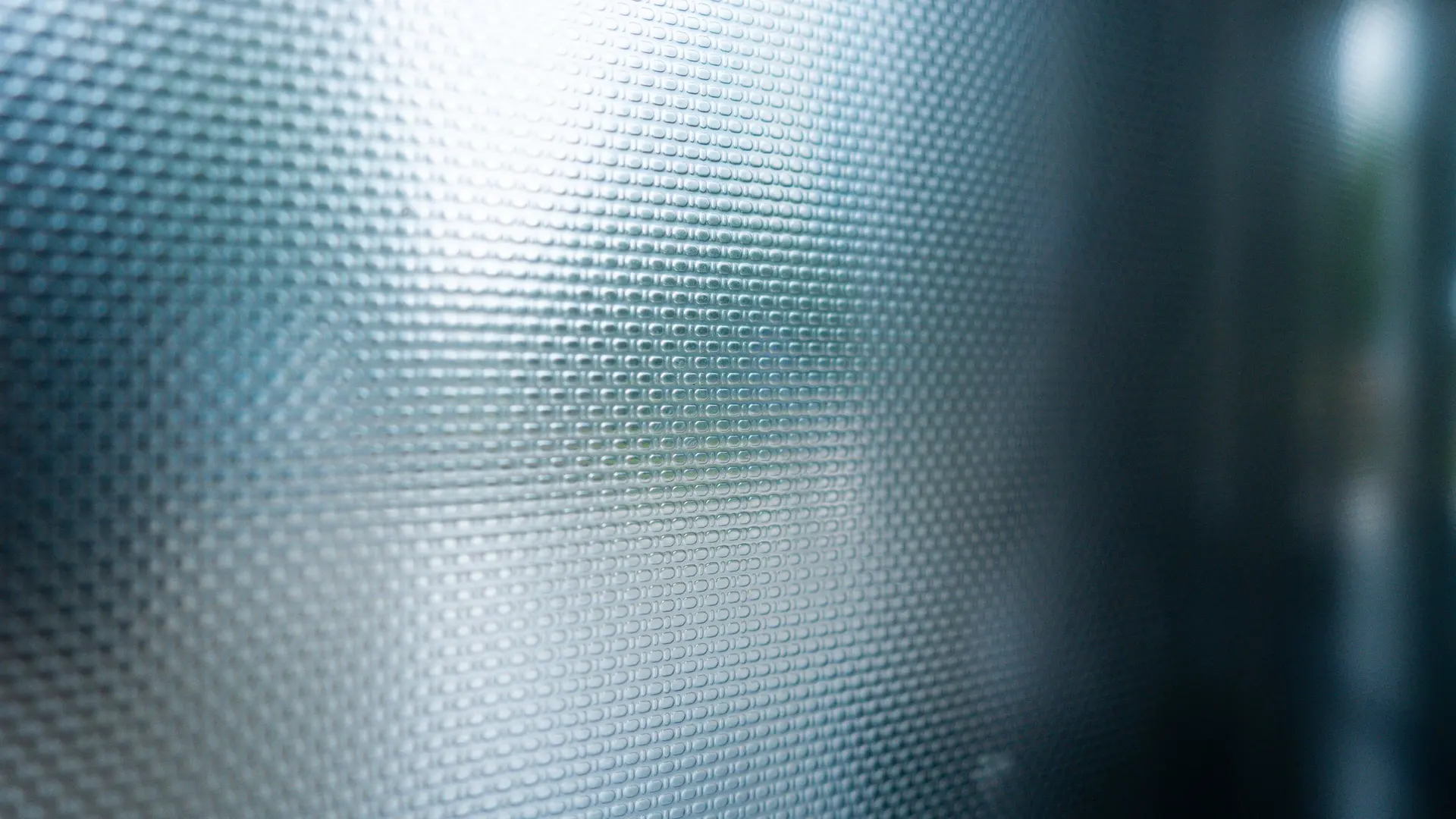Soft light on a textured smoked glass panel