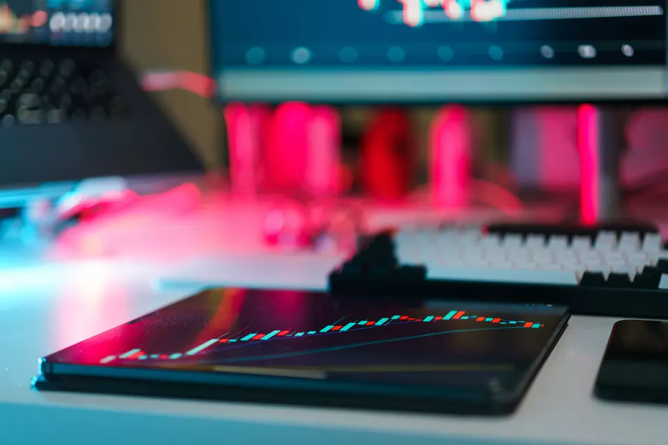 Financial charts on screens in a trading workspace