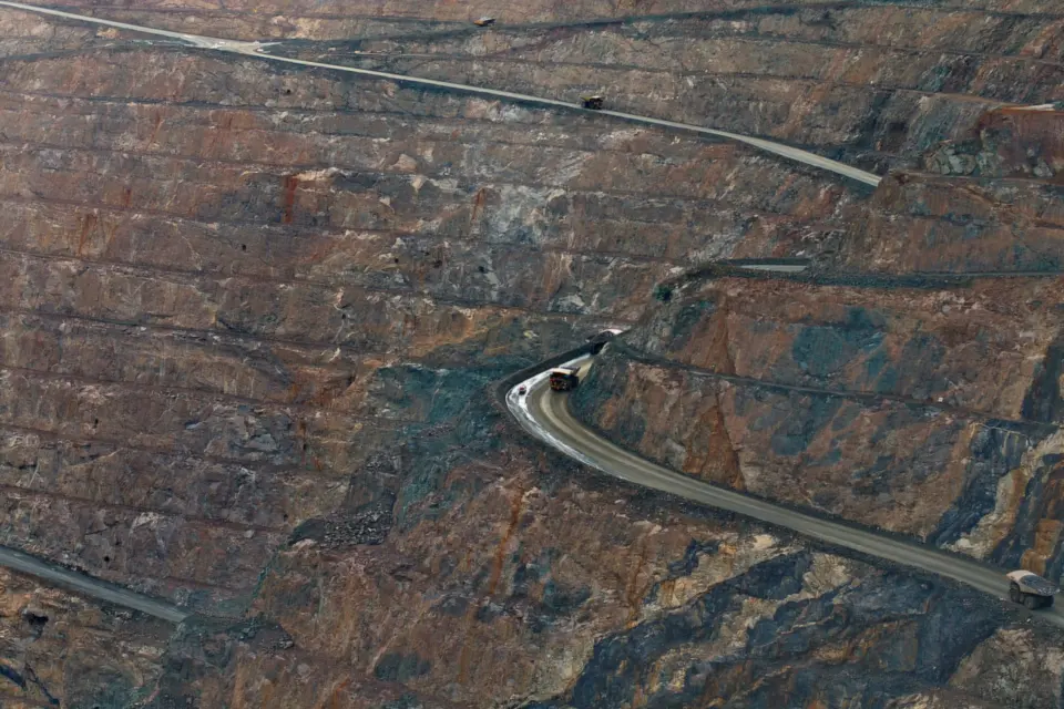 Aerial view of an open-cut mine with haul trucks on the roads