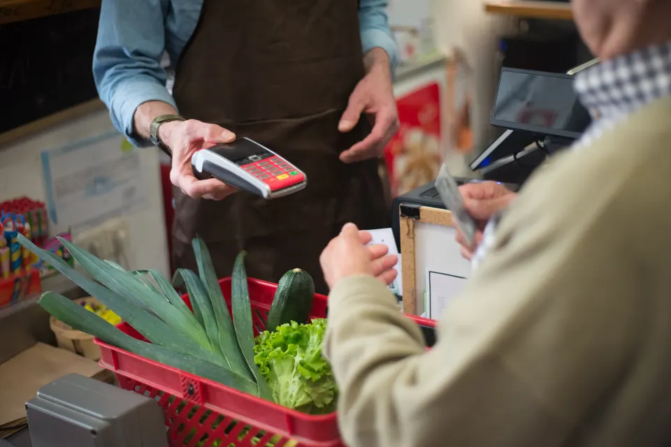 Customer paying by card at a shop checkout