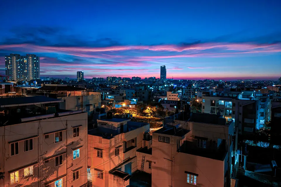 Bengaluru city buildings lit up at dusk