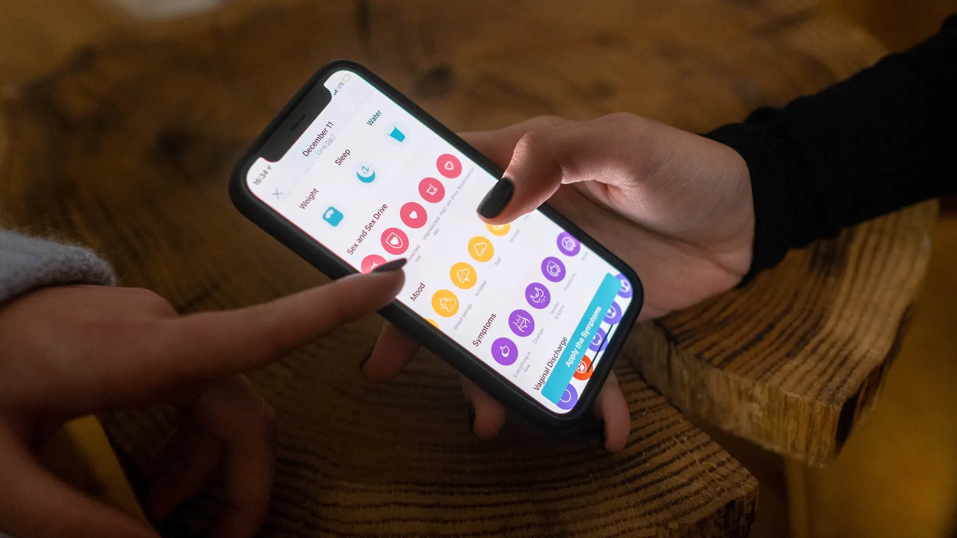 Hands using a colourful app on a smartphone